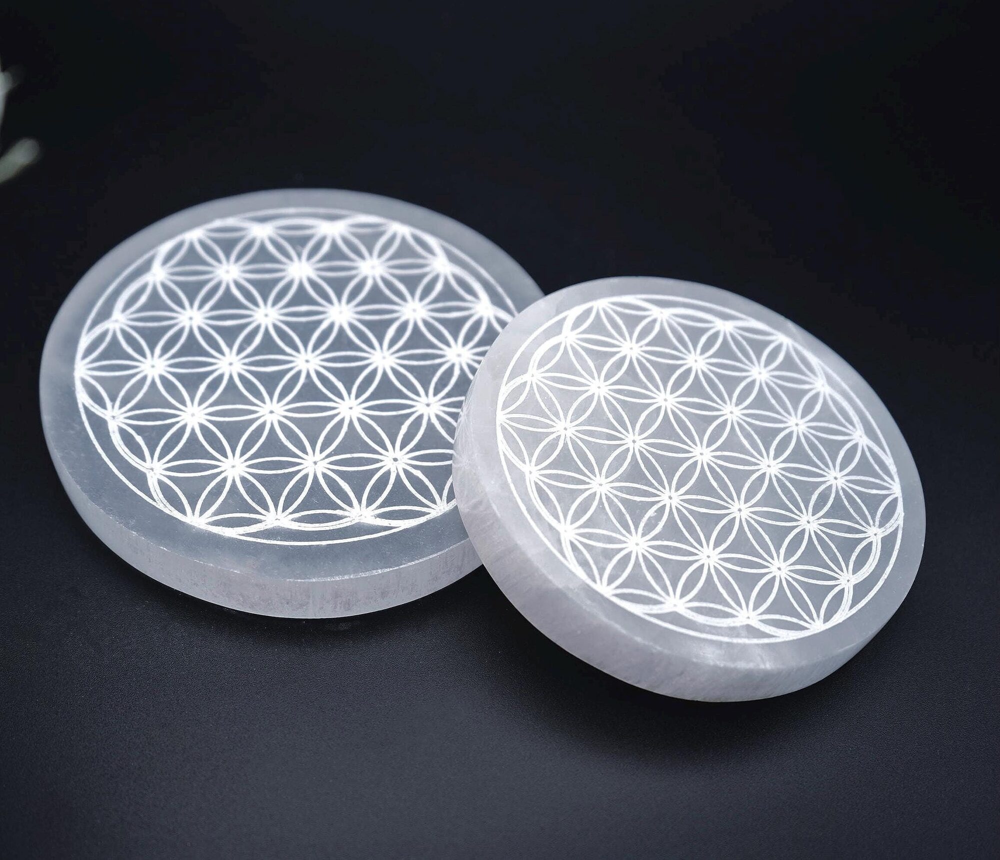 Selenite charging plate engraved with a flower of life